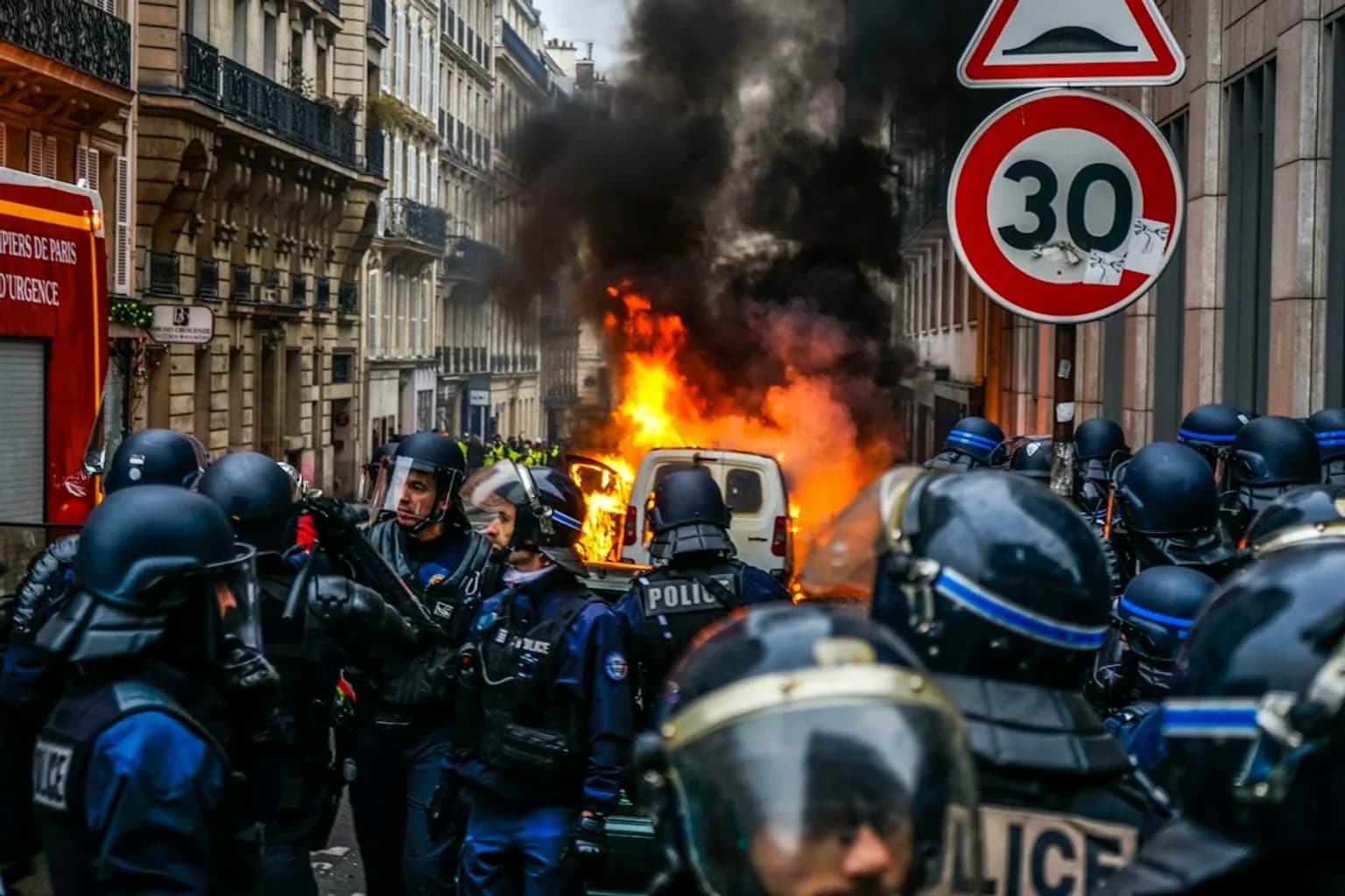 Protesters and emergency services on a French city street during the October 2026 riots