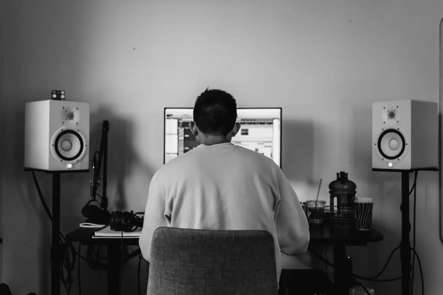 A software developer working at a computer with code on screen