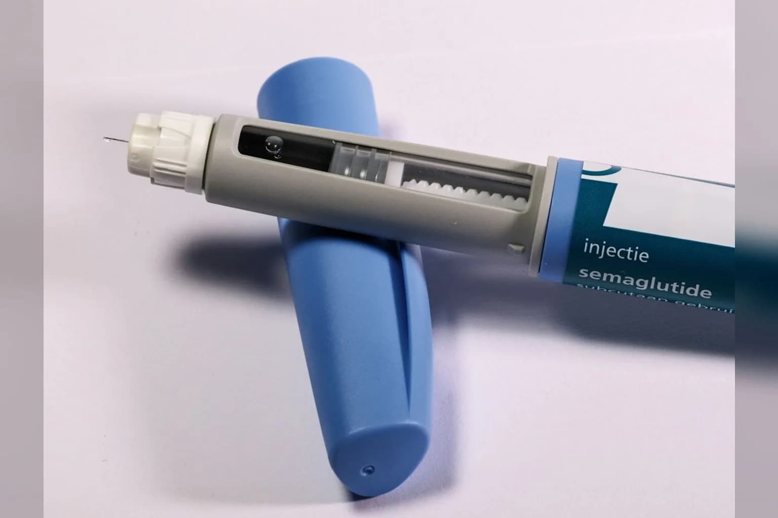 A GLP-1 injectable weight-loss drug pen on a plain surface