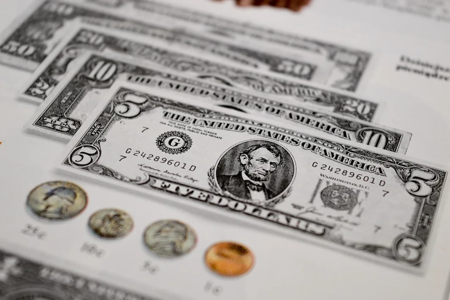 US dollar banknotes and coins arranged together