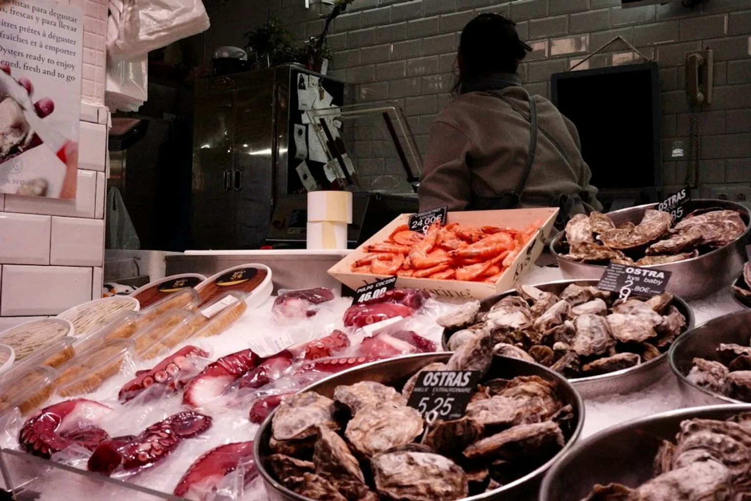 Fresh oysters displayed on ice at a seafood market counter