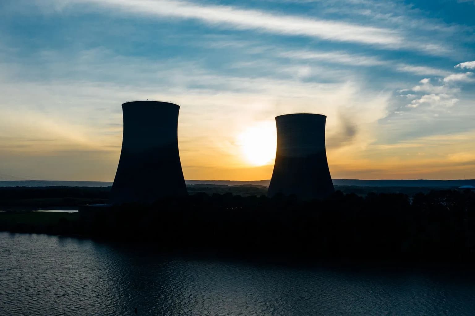 Vistra nuclear power plant exterior, with reactor buildings visible near a body of water