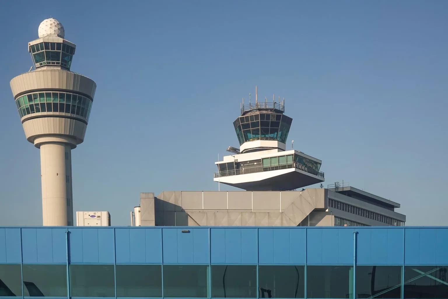 Air traffic controllers at workstations inside an FAA control centre, monitoring radar screens