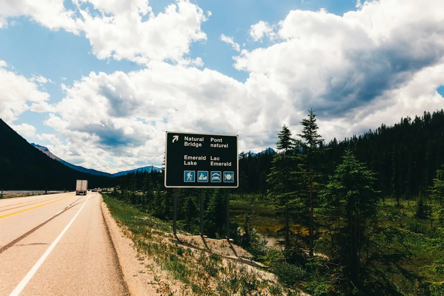 An oil pipeline running through a forested landscape in western Canada