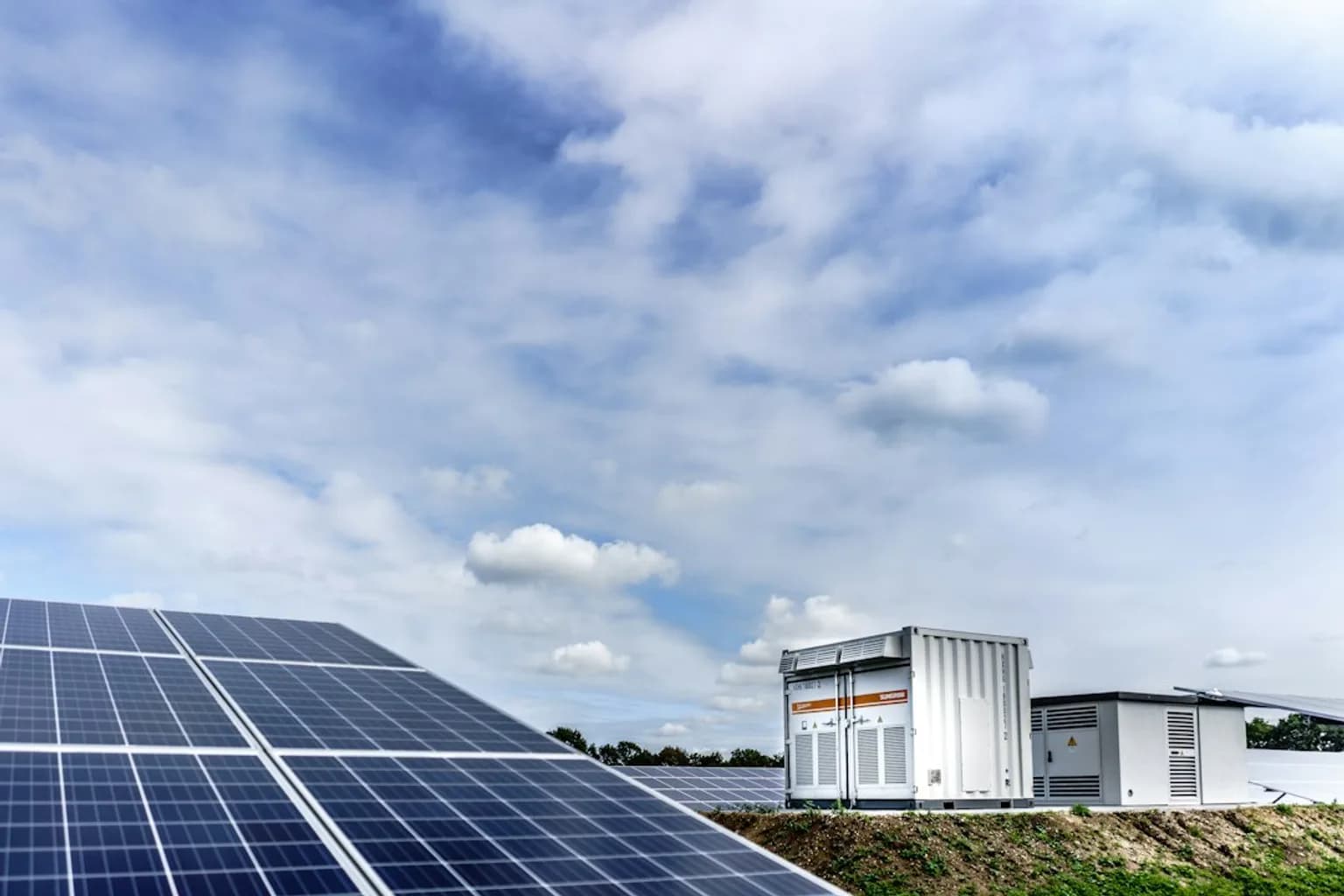 Rows of large battery energy storage units at a utility-scale installation