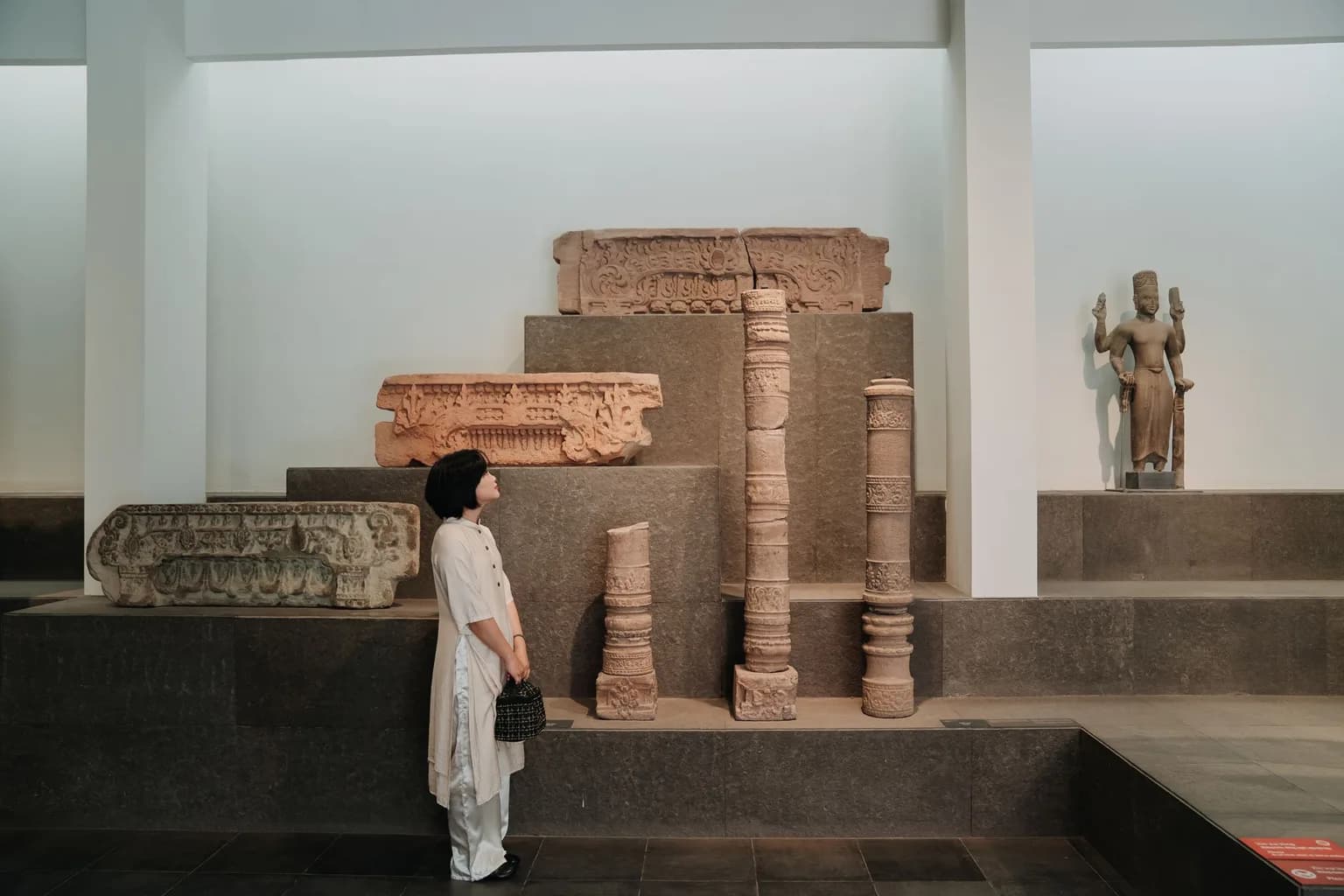 A Mesoamerican stone sculpture displayed in a museum setting