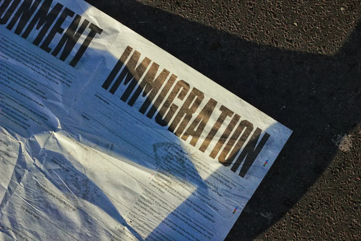 People being escorted by immigration enforcement officers near a deportation flight on a tarmac