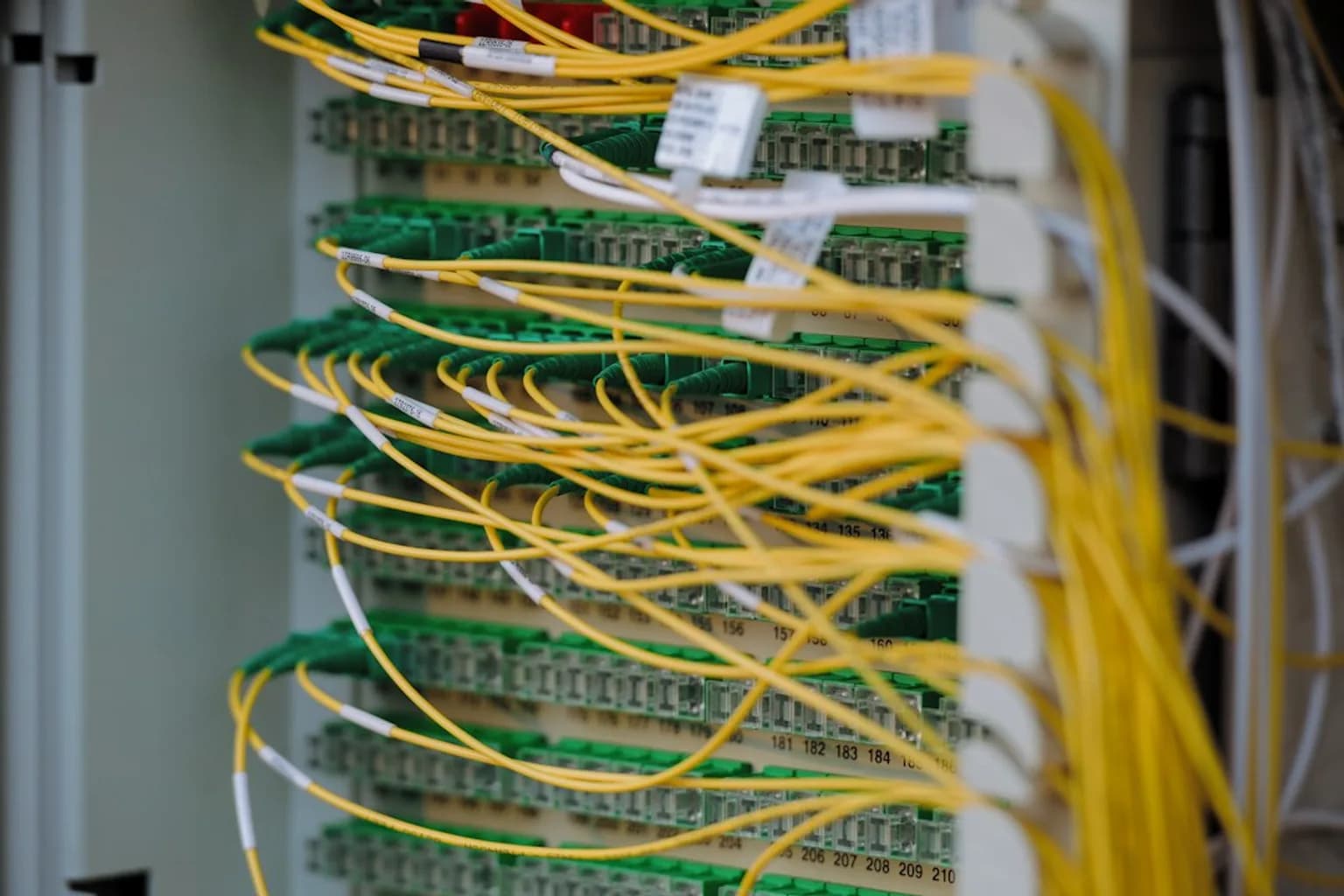 Rows of illuminated server racks inside a large data centre facility