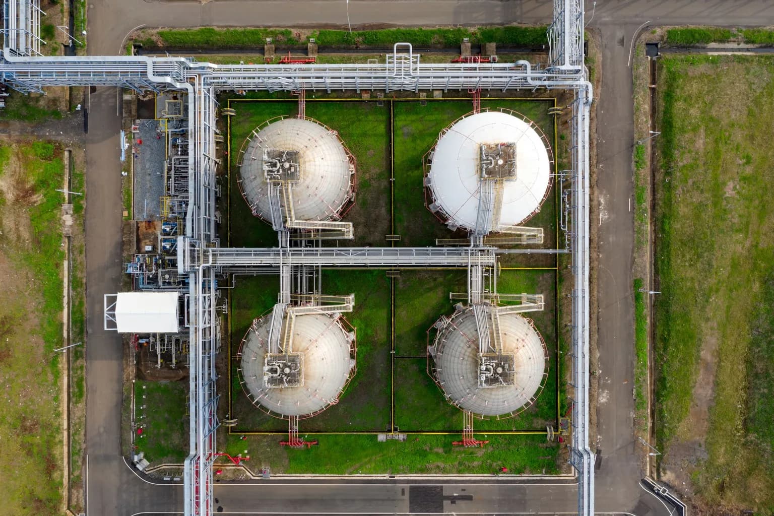 Aerial view of large crude oil storage tanks at an industrial refinery