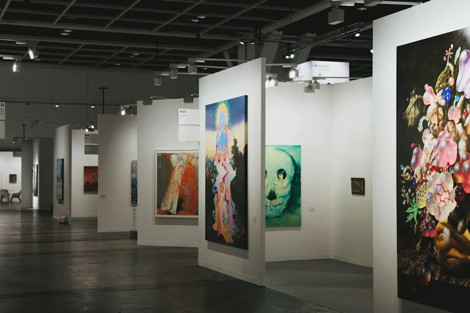 Visitors browsing artwork at an Art Basel fair