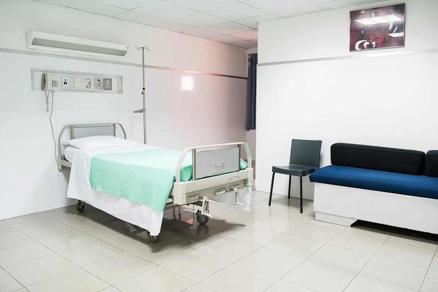 A clinical infusion room with empty chairs and IV stands, used for administering experimental treatments in a trial setting.