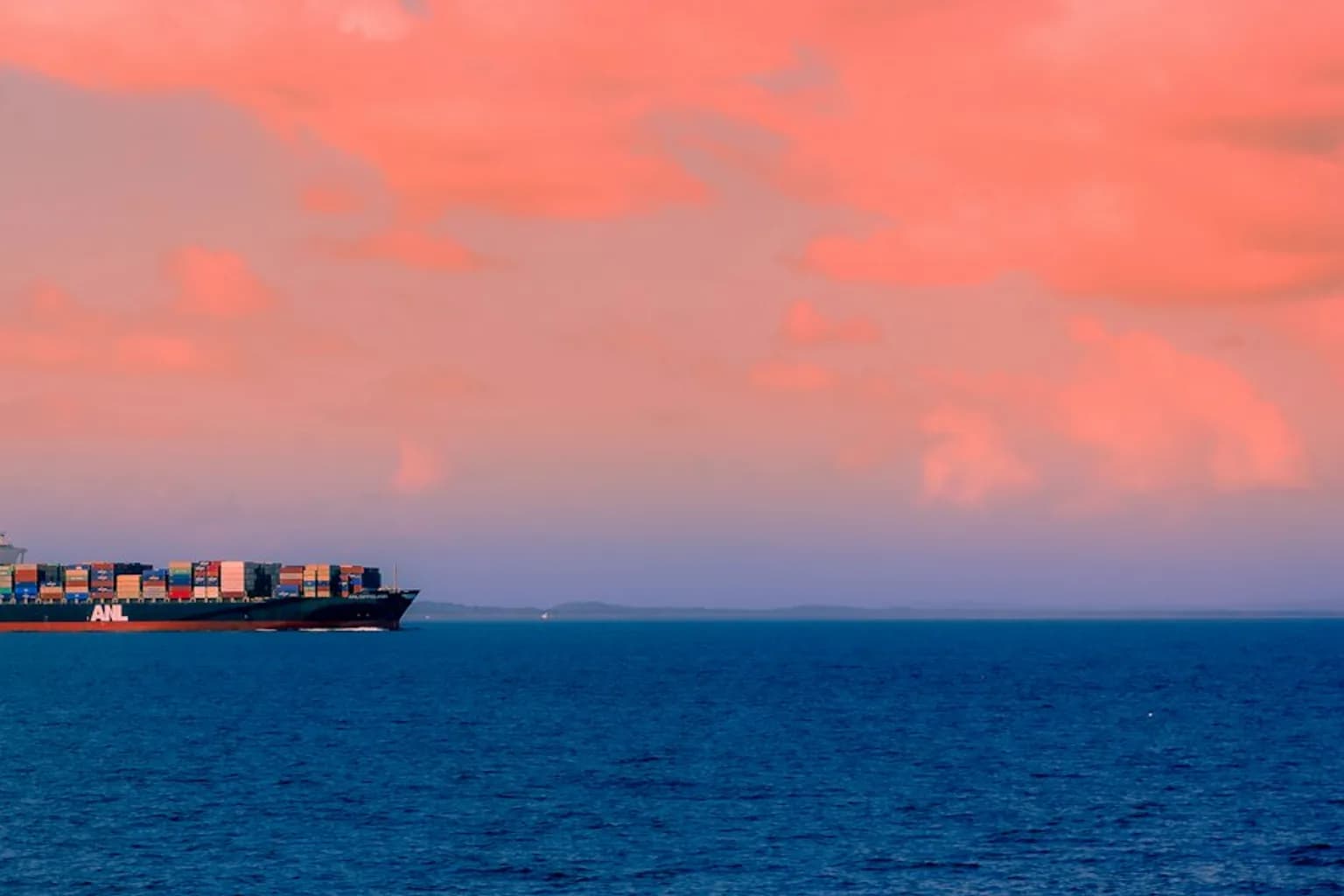 A commercial cargo ship navigates the Black Sea near a grain export terminal