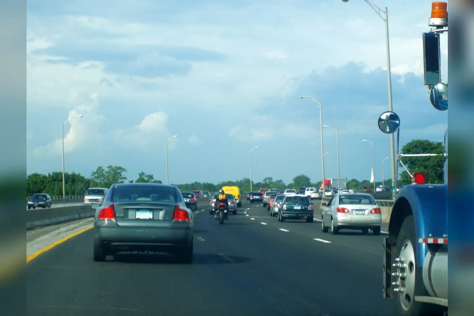 Cars and trucks travel along a busy US highway