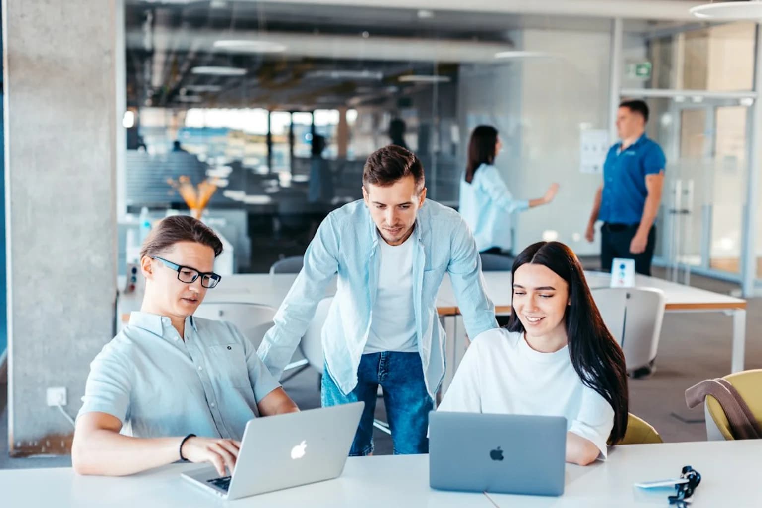Young professionals working at desks in a modern office environment