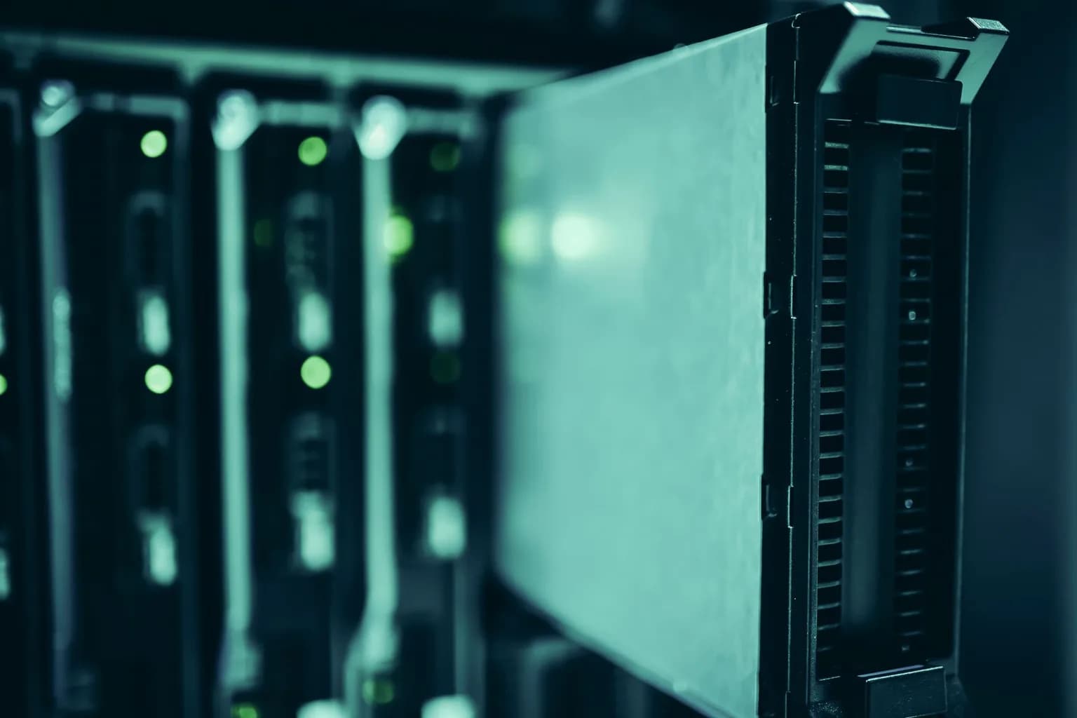 Rows of illuminated server racks inside a large data centre facility
