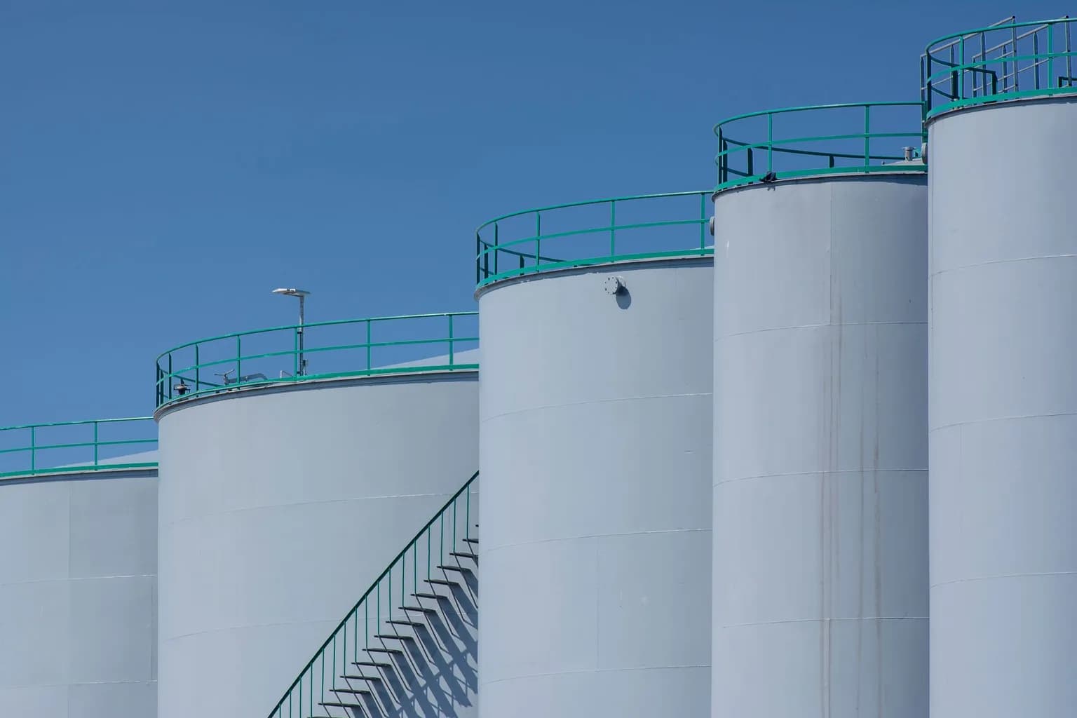 An oil refinery in Russia with industrial towers and pipework against a cloudy sky