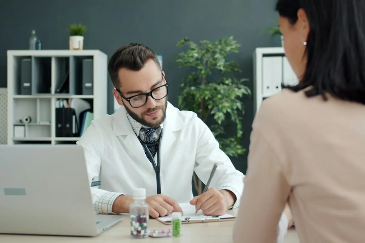 A woman in conversation with a doctor during a medical consultation