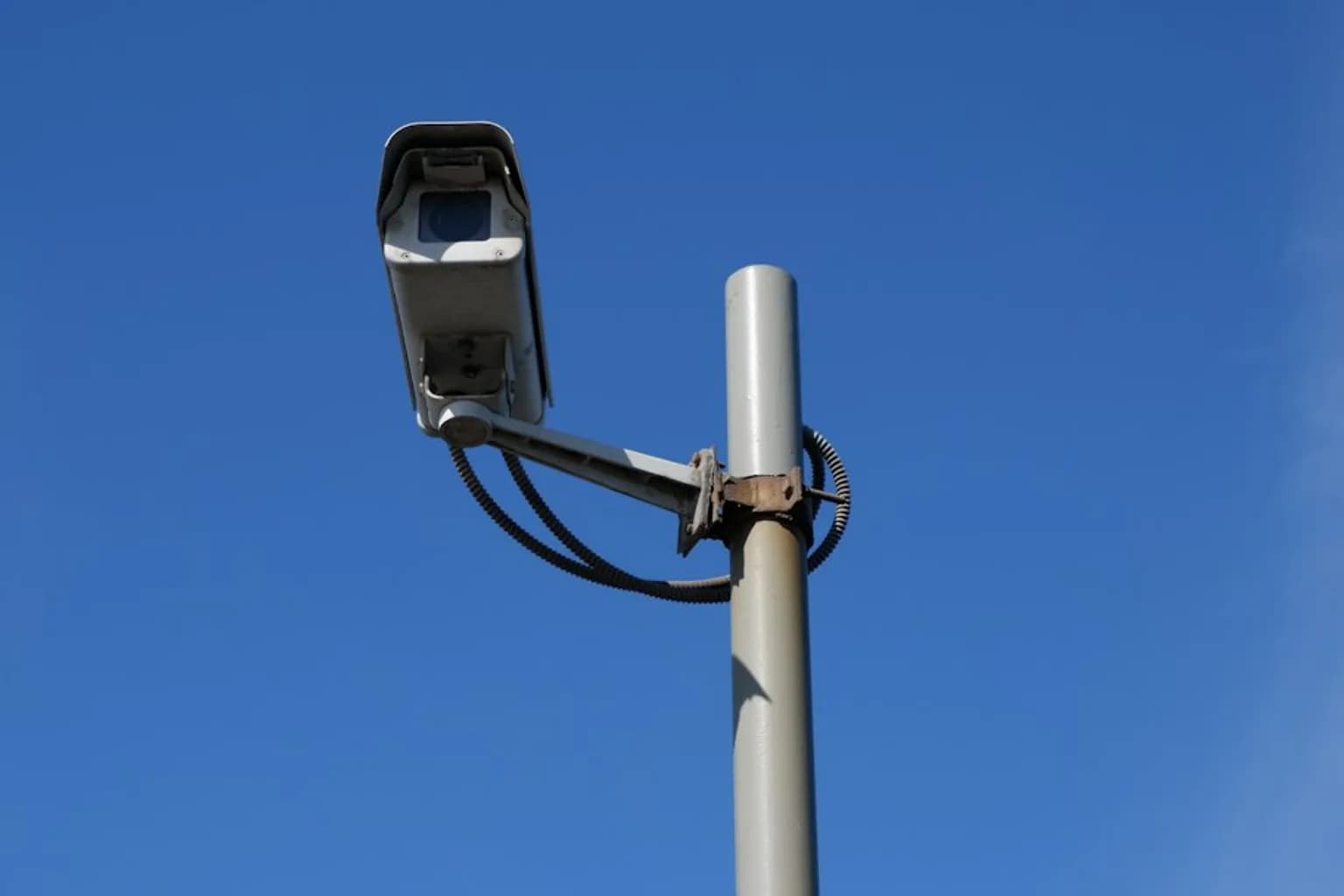 A Flock Safety automated licence-plate reader camera mounted on a roadside pole