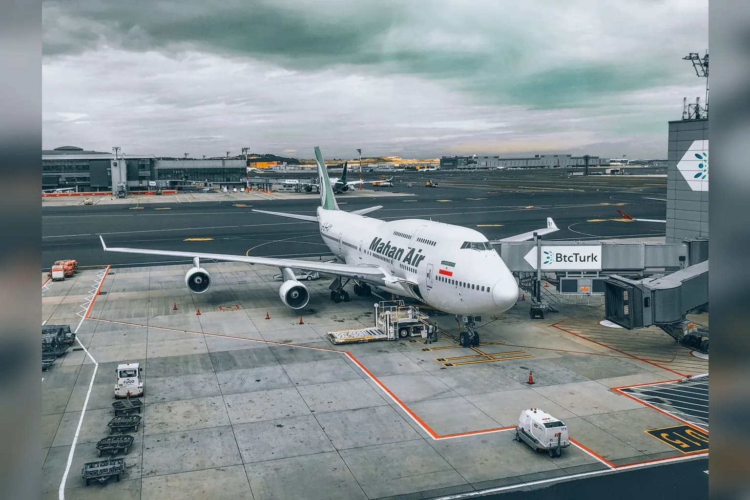 An Iran Air passenger aircraft parked at an airport terminal