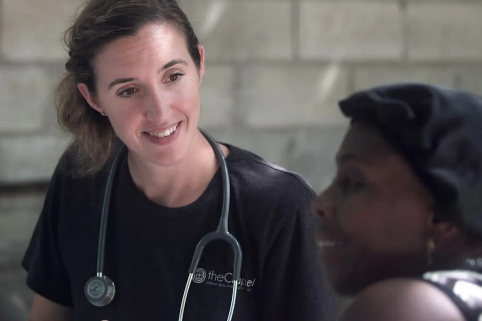 A healthcare worker attends to a patient at a clinic in Africa