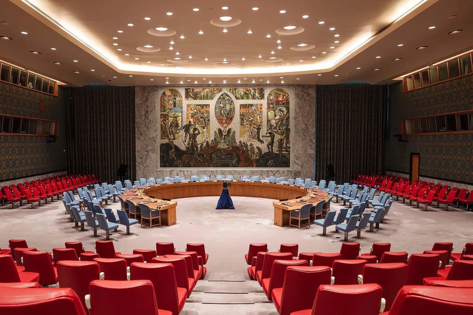 The UN Security Council chamber in New York, with the horseshoe table and member state nameplates visible