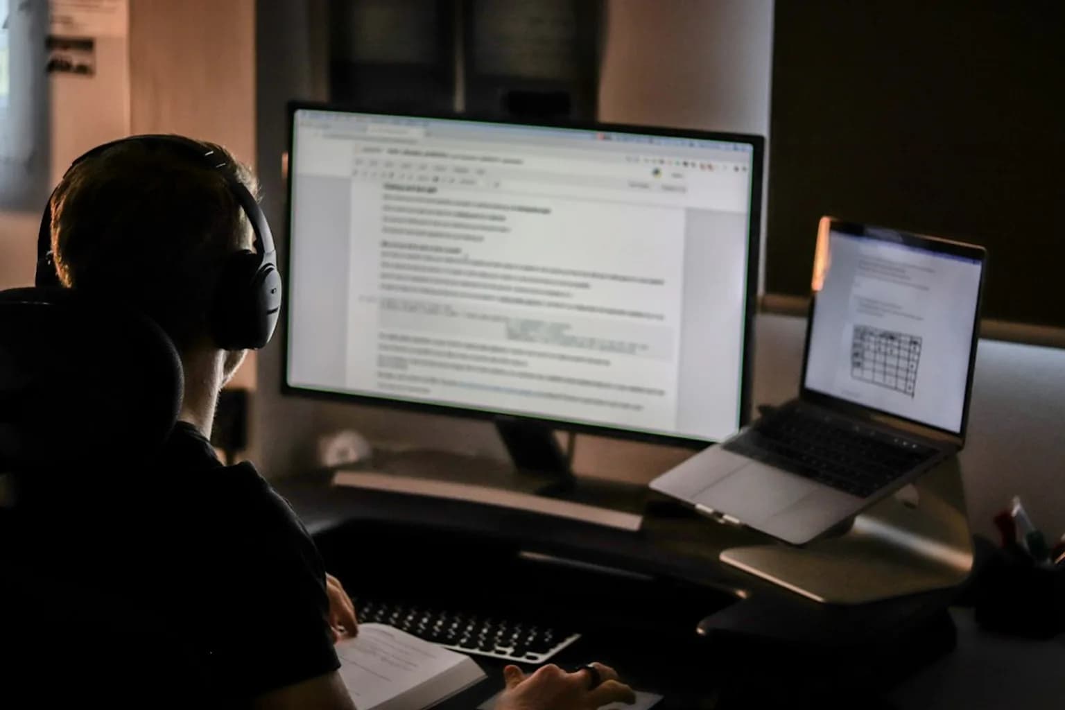 A security researcher working at a computer displaying lines of code