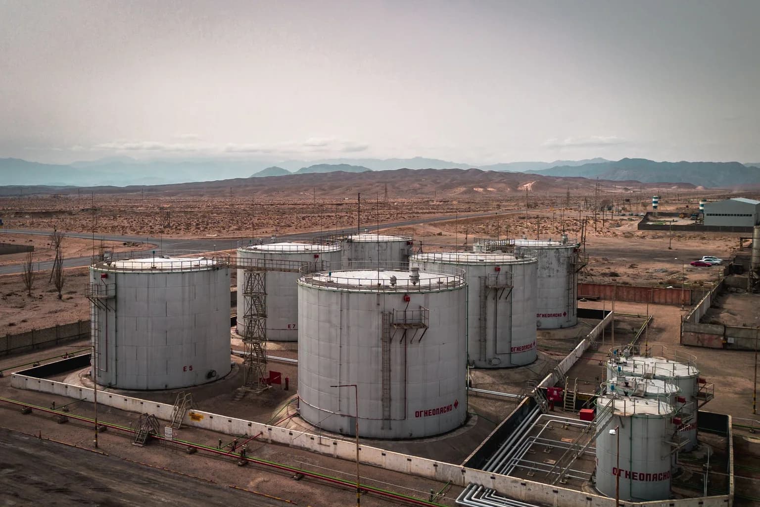 An oil pipeline stretching across arid desert terrain in Saudi Arabia.