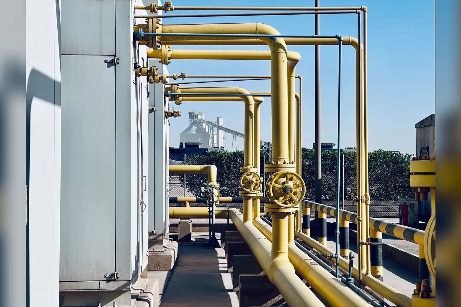 An oil refinery facility in Saudi Arabia with industrial processing towers and pipelines