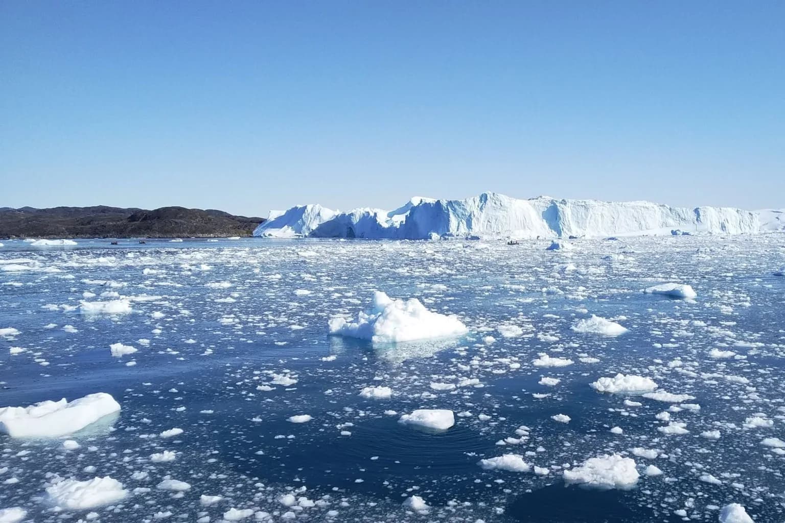 A glacier on the Greenland ice sheet calving into the ocean