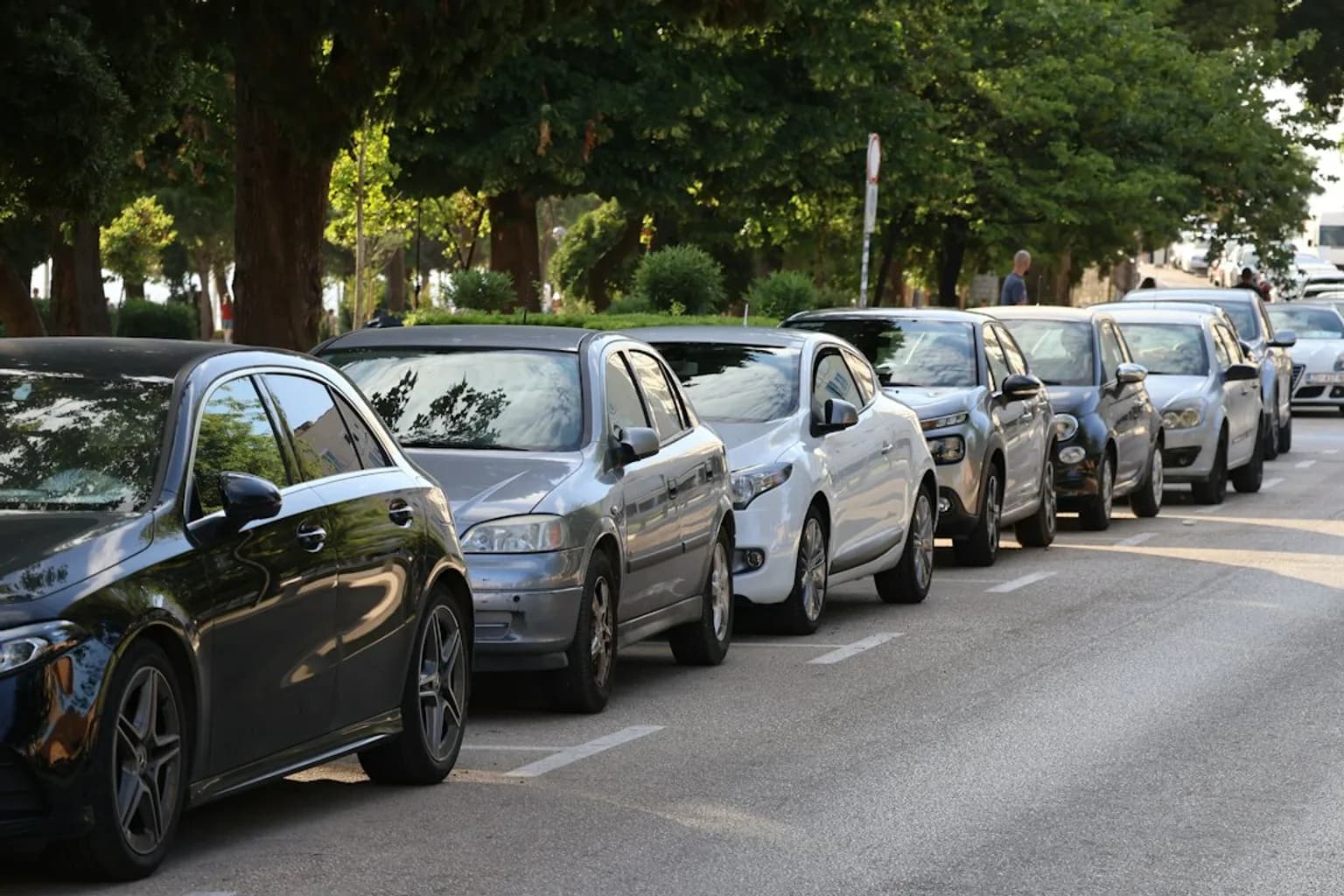 A row of Chinese-made hybrid cars at a European dealership or port